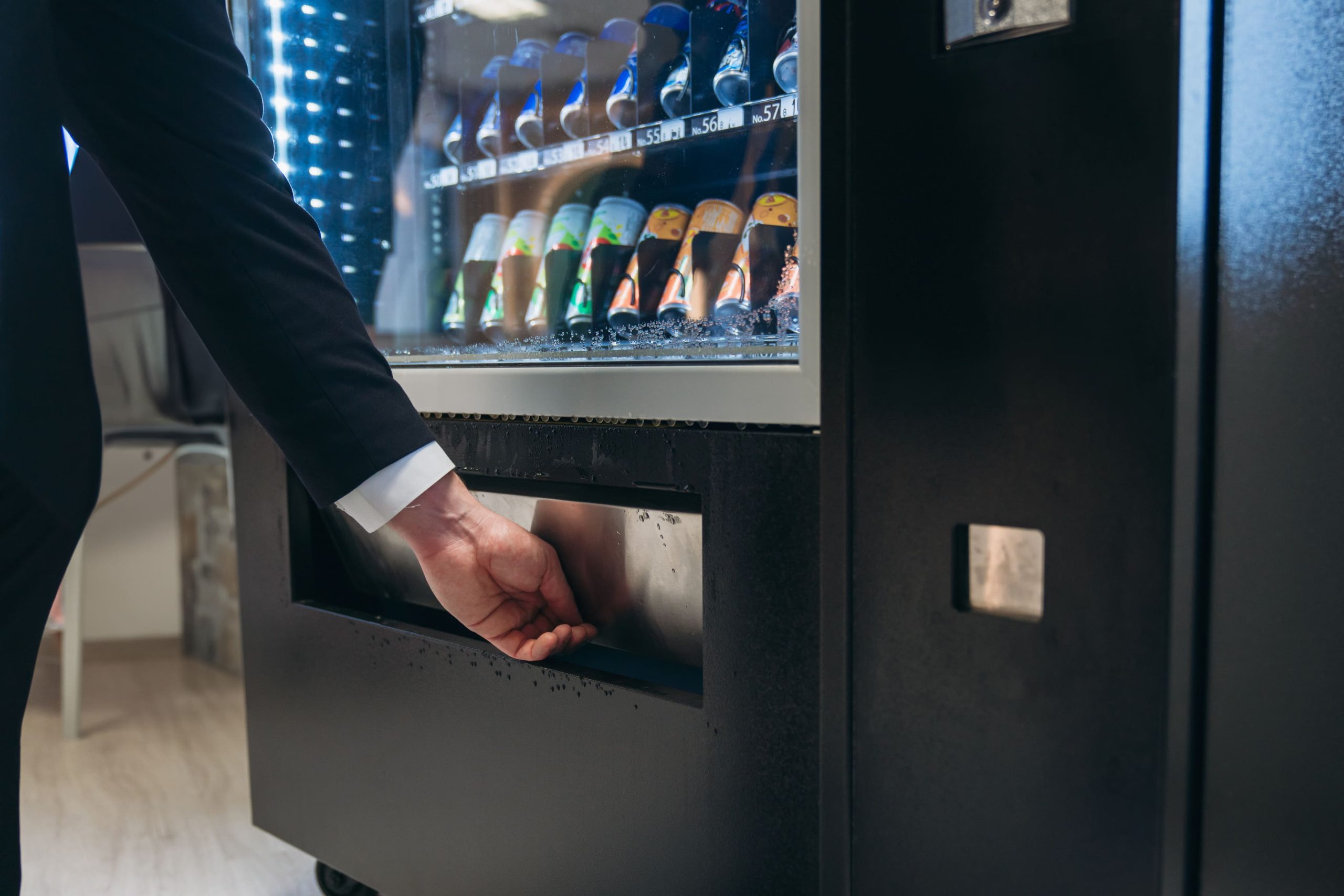 close-up-hand-of-man-pushing-button-on-vending-mac-2023-12-06-22-11-49-utc (1) (1)